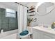 Cozy bathroom features a shower-tub combo with green tile, a modern vanity and updated fixtures at 783 Cornelia Ct, Orlando, FL 32811