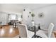 Open-concept dining area with hardwood floors and modern glass table at 783 Cornelia Ct, Orlando, FL 32811