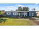 Charming single-story home featuring front yard, and covered front entry with decorative seating at 783 Cornelia Ct, Orlando, FL 32811