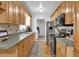 Functional kitchen featuring wooden cabinetry, stainless steel appliances, and hardwood floors at 783 Cornelia Ct, Orlando, FL 32811