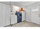 Laundry room with washer, dryer, and extra storage space by the door at 783 Cornelia Ct, Orlando, FL 32811