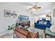 Living room with blue sofa, tile flooring, and entertainment center at 783 Cornelia Ct, Orlando, FL 32811