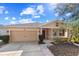 Charming single-Gathering home featuring a two-car garage and well-maintained landscaping in a sunny setting at 8008 Page Ct, Haines City, FL 33844