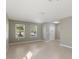 Bright living room featuring tile flooring, neutral paint, and natural light from two windows at 8008 Page Ct, Haines City, FL 33844