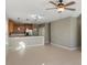 Open-concept living room with tile floors, and an adjacent kitchen with stainless steel appliances at 8008 Page Ct, Haines City, FL 33844