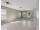 Spacious living room with tile floors, neutral paint, and two sunny windows at 8008 Page Ct, Haines City, FL 33844