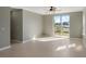 Bright living room with tile flooring, fan, and a sliding glass door to the backyard at 8008 Page Ct, Haines City, FL 33844
