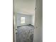 Bright bedroom with grey carpet and large window at 1148 Pomelo St, Davenport, FL 33837