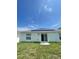 House back view, featuring a solar panel system and sliding glass door at 1148 Pomelo St, Davenport, FL 33837
