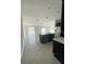 Open concept kitchen with island and view into living area at 1148 Pomelo St, Davenport, FL 33837