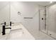Stylish bathroom featuring double sinks, quartz counters, and a sleek walk-in shower at 11842 Sunsail Ave, Orlando, FL 32832