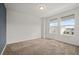 Comfortable carpeted bedroom with a calming accent wall and ample natural light at 11842 Sunsail Ave, Orlando, FL 32832