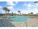 Beautiful community pool featuring palm trees, comfortable seating, and ample space for relaxation at 11842 Sunsail Ave, Orlando, FL 32832
