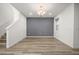 Large dining room area with wood-look floors and light fixture, steps, and neutral gray wall at 11842 Sunsail Ave, Orlando, FL 32832