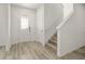 Bright foyer featuring a staircase, coat closet, and a front door with decorative glass at 11842 Sunsail Ave, Orlando, FL 32832