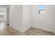 Bright hallway with wood-look flooring and natural light entering through a window at 11842 Sunsail Ave, Orlando, FL 32832