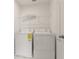 Functional laundry room with washer, dryer, and wire shelving for organization at 11842 Sunsail Ave, Orlando, FL 32832