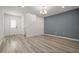 Open-concept living area with wood-look floors and a view of the staircase and front door at 11842 Sunsail Ave, Orlando, FL 32832
