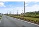 Neighborhood street view with sidewalks, landscaping, and street lights at 11842 Sunsail Ave, Orlando, FL 32832