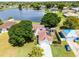 Aerial view of a charming home with solar panels and a serene lake backdrop at 119 Floral Ct, Kissimmee, FL 34743
