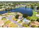 Aerial view of a lovely home on a large lake and beautiful neighborhood at 119 Floral Ct, Kissimmee, FL 34743