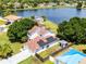 Stunning aerial view of home featuring solar panels, and a lovely lake at 119 Floral Ct, Kissimmee, FL 34743