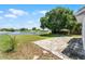 A backyard features a lake, paver patio, and mature tree at 119 Floral Ct, Kissimmee, FL 34743