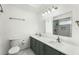 Bathroom features a double vanity with marble countertop, mirrors, and tiled shower at 119 Floral Ct, Kissimmee, FL 34743
