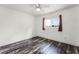 Bedroom with laminate flooring, a ceiling fan, and a window at 119 Floral Ct, Kissimmee, FL 34743