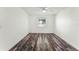 Bright bedroom featuring a ceiling fan, wood-look floors, and natural light from the window at 119 Floral Ct, Kissimmee, FL 34743