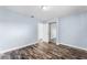 Bedroom featuring laminate flooring and sliding mirror closet doors at 119 Floral Ct, Kissimmee, FL 34743
