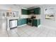 Stylish kitchen featuring green cabinetry, stainless steel appliances, and an open layout at 119 Floral Ct, Kissimmee, FL 34743
