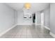 Bright, open-concept living area with tile flooring and a view into the adjacent kitchen at 119 Floral Ct, Kissimmee, FL 34743