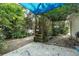 Lush backyard featuring a shady area with brick accents and diverse foliage and a small bench at 1221 Thunder Trl, Maitland, FL 32751