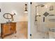 Elegant bathroom featuring a carved wood vanity, tile accents and a walk-in shower at 1221 Thunder Trl, Maitland, FL 32751