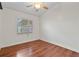 Bright bedroom with wood flooring, window overlooking the backyard and neutral walls at 1221 Thunder Trl, Maitland, FL 32751