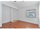Bedroom with wood flooring, closet and a window overlooking the backyard at 1221 Thunder Trl, Maitland, FL 32751
