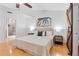 Calm bedroom featuring light walls, a ceiling fan, a stylish barn door, and an ensuite bathroom at 1221 Thunder Trl, Maitland, FL 32751