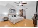 Cozy bedroom with wood floors, a ceiling fan, an art piece and access to an ensuite bathroom at 1221 Thunder Trl, Maitland, FL 32751