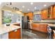 Well-equipped kitchen featuring stainless steel appliances, granite countertops, and custom wood cabinetry at 1221 Thunder Trl, Maitland, FL 32751