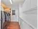 Bright laundry room featuring modern appliances, white cabinets and a door to the exterior at 1221 Thunder Trl, Maitland, FL 32751