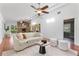Bright and airy living room with vaulted ceilings, skylights, and a stylish stone fireplace with a ceiling fan at 1221 Thunder Trl, Maitland, FL 32751