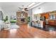 Open-concept living room featuring vaulted ceilings, a stone fireplace, and a breakfast bar with a view of the backyard at 1221 Thunder Trl, Maitland, FL 32751