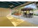 Inviting outdoor space with covered patio, tiki bar, grill, and adjacent wooden bar area at 1221 Thunder Trl, Maitland, FL 32751