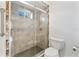 Walk-in shower with glass doors, window and stone tile at 1221 Thunder Trl, Maitland, FL 32751