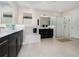 Bright bathroom featuring double vanity, soaking tub, glass enclosed shower, and white tile at 13557 Parkfield Way, Winter Garden, FL 34787