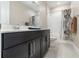 Clean bathroom featuring a dark vanity with chrome finishes and a shower-tub combo at 13557 Parkfield Way, Winter Garden, FL 34787
