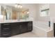 Bathroom with soaking tub, sleek vanity, and plenty of counter space at 13557 Parkfield Way, Winter Garden, FL 34787