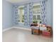 Empty bedroom with blue walls and curtains, ready for personalization and boxes at 13557 Parkfield Way, Winter Garden, FL 34787