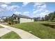 Side view of house with mature landscaping and large lawn at 13557 Parkfield Way, Winter Garden, FL 34787